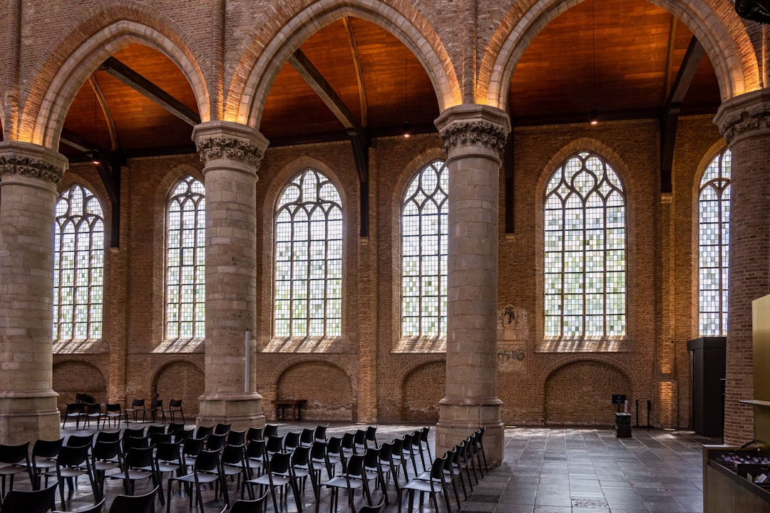 a room with rows of chairs and large windows